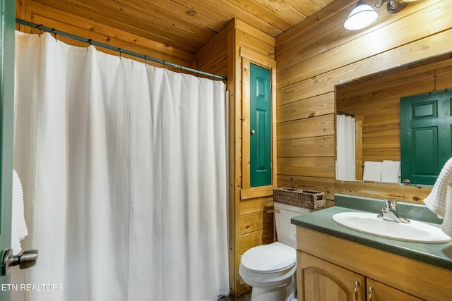 bathroom with wood walls, vanity, wooden ceiling, and toilet