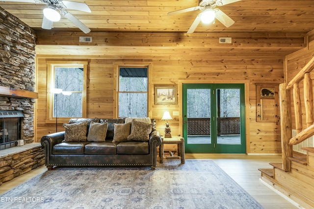 living room with wood-type flooring, wood walls, and wood ceiling