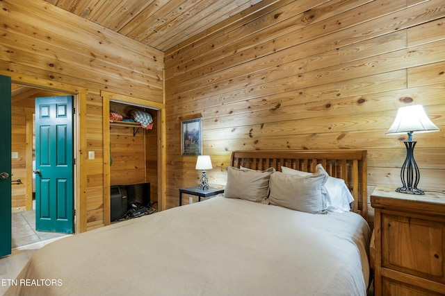 bedroom featuring wood walls, a closet, and wood ceiling