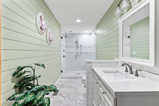 bathroom with wooden walls, a shower with door, vanity, and toilet