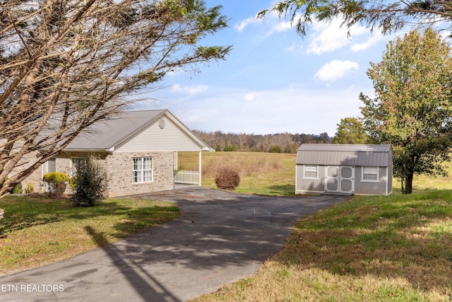 view of home's exterior featuring a yard and a storage shed