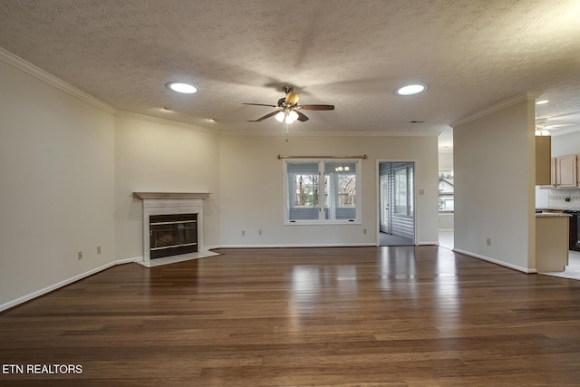 unfurnished living room featuring a textured ceiling, dark hardwood / wood-style floors, and ornamental molding