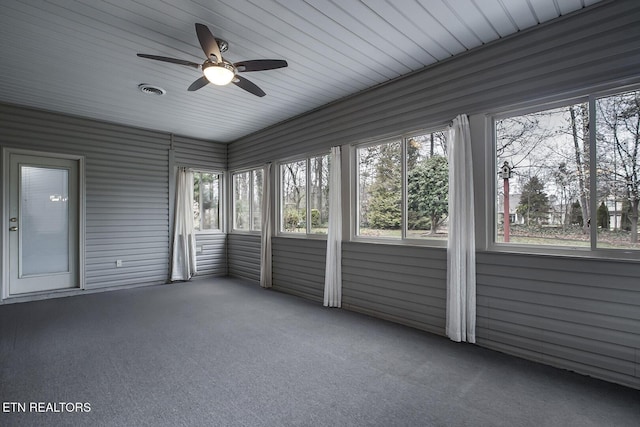 unfurnished sunroom with plenty of natural light and ceiling fan