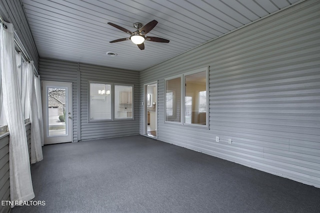 unfurnished sunroom featuring ceiling fan