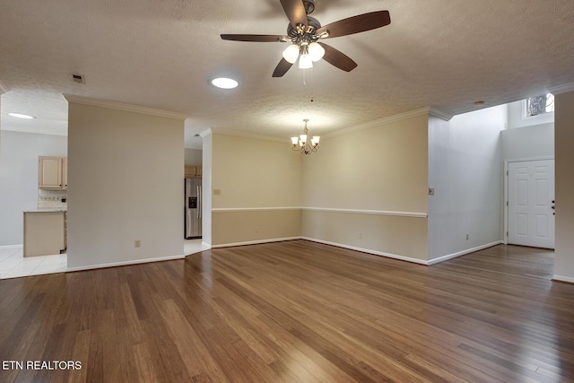 spare room with light wood-type flooring, ornamental molding, and a textured ceiling