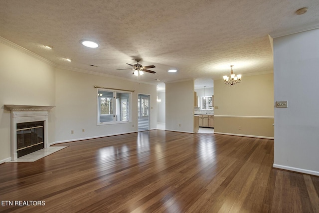 unfurnished living room with ceiling fan with notable chandelier, wood-type flooring, crown molding, and a textured ceiling