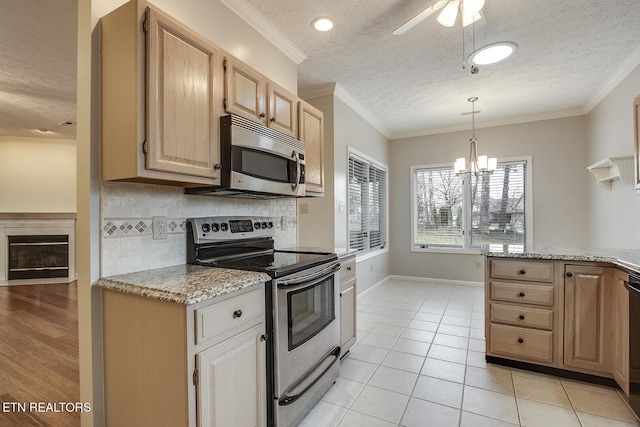 kitchen featuring light stone countertops, a textured ceiling, tasteful backsplash, light tile patterned floors, and stainless steel appliances