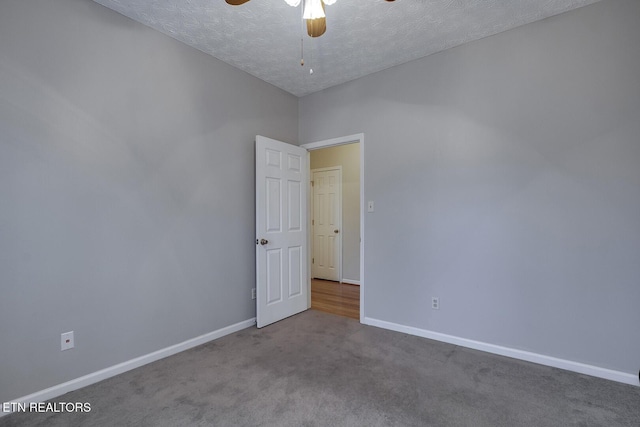 unfurnished room featuring ceiling fan, carpet, and a textured ceiling