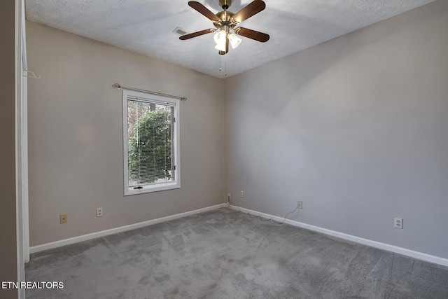 carpeted empty room featuring a textured ceiling and ceiling fan