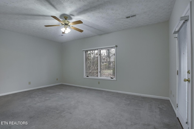 unfurnished bedroom featuring ceiling fan, a textured ceiling, and dark colored carpet