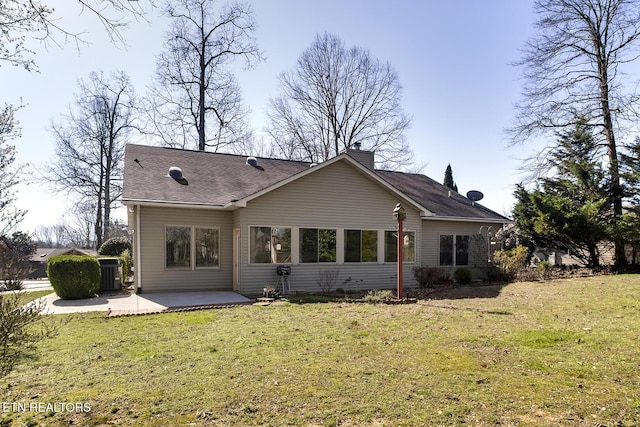 rear view of property featuring cooling unit, a patio area, and a lawn