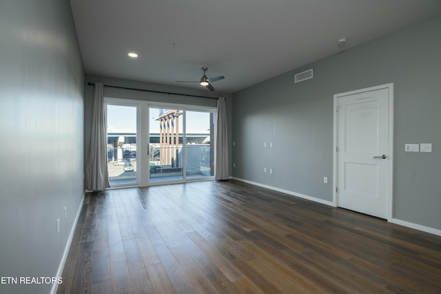 unfurnished room featuring ceiling fan and dark hardwood / wood-style floors