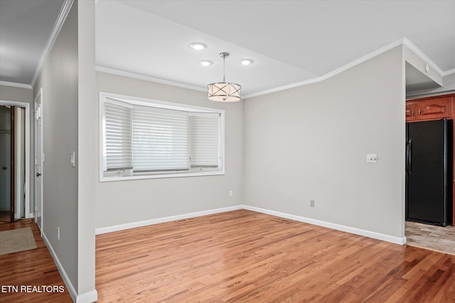 interior space featuring light hardwood / wood-style floors and crown molding