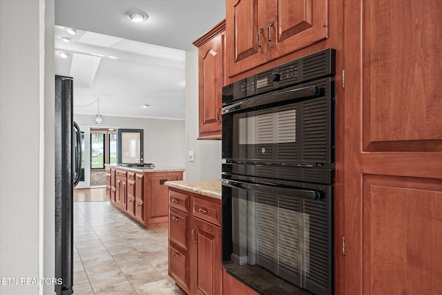 kitchen with black appliances, french doors, light stone counters, and light tile patterned floors