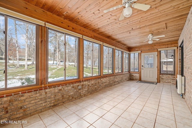 unfurnished sunroom with ceiling fan, wooden ceiling, and heating unit