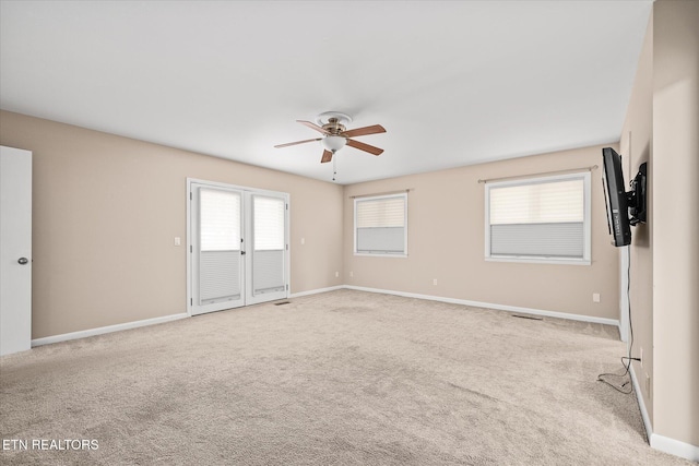 empty room with light colored carpet and ceiling fan