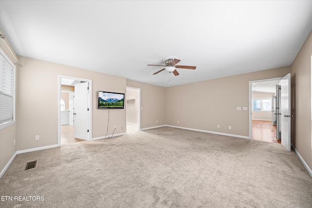 unfurnished living room with light carpet and ceiling fan