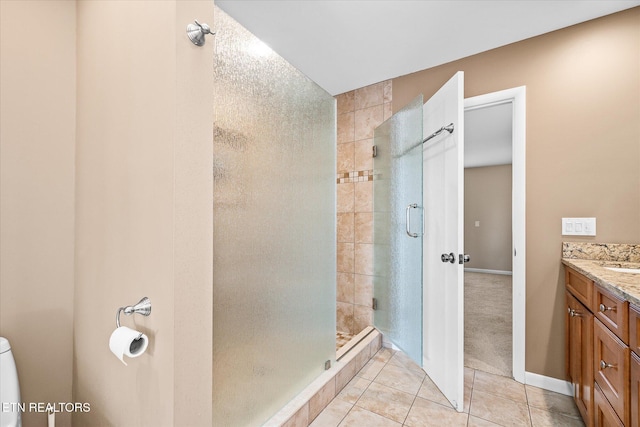 bathroom featuring vanity, walk in shower, and tile patterned flooring