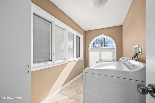 laundry area with light tile patterned flooring and washing machine and clothes dryer