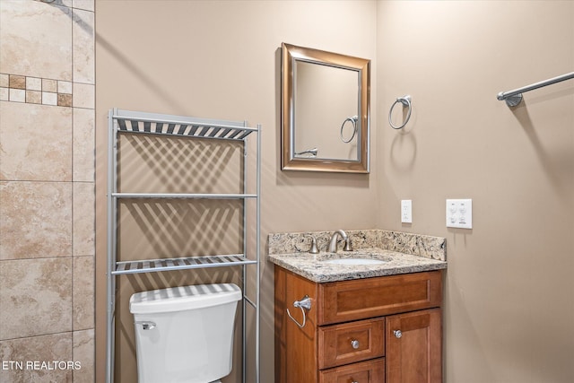 bathroom with toilet and vanity