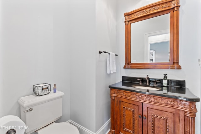 bathroom featuring toilet and vanity