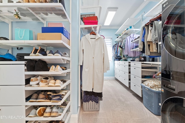 walk in closet with light colored carpet