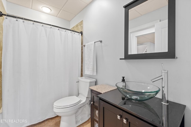 bathroom with toilet, walk in shower, and vanity