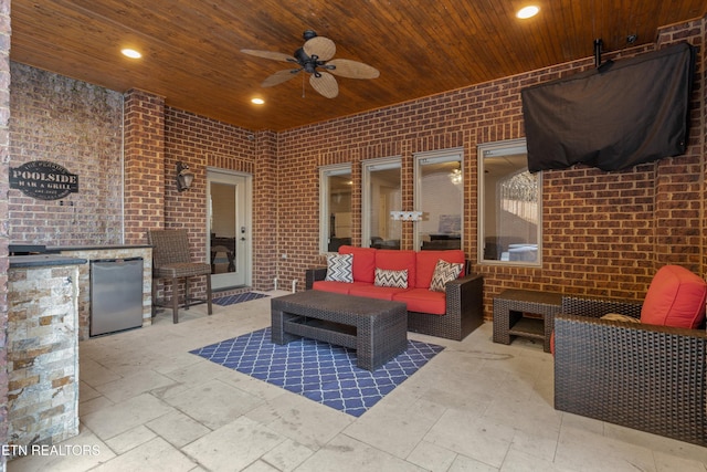 view of patio featuring area for grilling, exterior bar, ceiling fan, and an outdoor living space