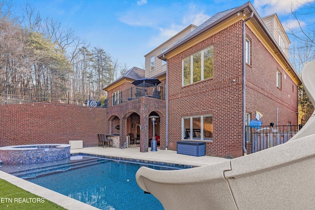 view of pool with a patio and an in ground hot tub