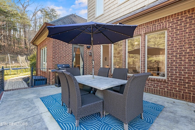 view of patio / terrace with a grill and a trampoline