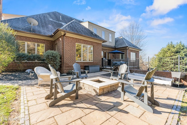 back of house featuring an outdoor fire pit and a patio area