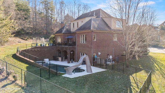 back of house featuring a patio area and a yard