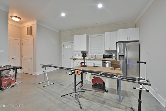 kitchen featuring white cabinetry, sink, crown molding, and appliances with stainless steel finishes