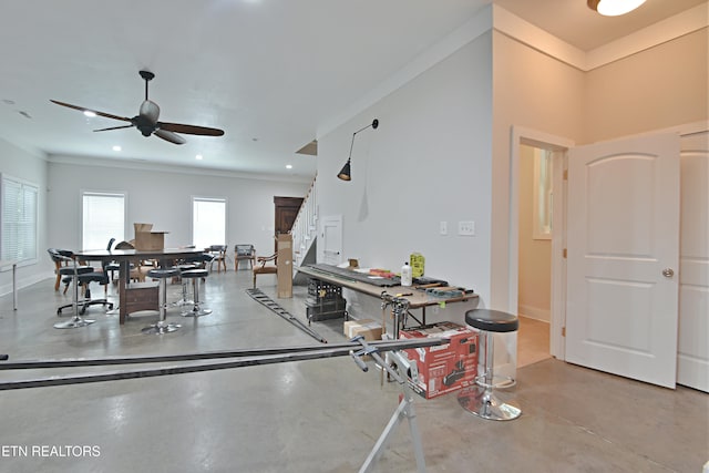 interior space featuring ceiling fan and ornamental molding