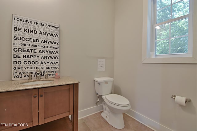 bathroom featuring tile patterned floors, vanity, and toilet