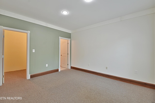 empty room with light colored carpet and ornamental molding