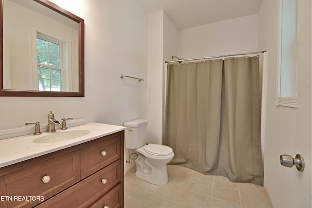 bathroom featuring curtained shower, vanity, and toilet