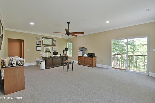 office area with light colored carpet, plenty of natural light, crown molding, and ceiling fan