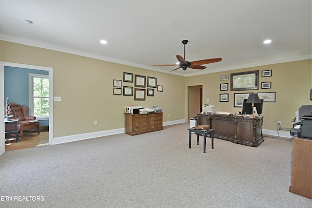 office area with light carpet, crown molding, and ceiling fan