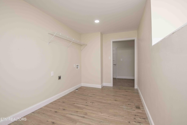 laundry room with hookup for a washing machine, light hardwood / wood-style flooring, and electric dryer hookup