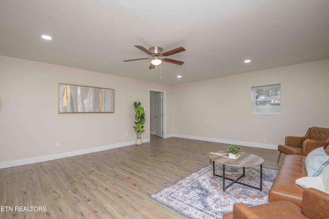 living room featuring hardwood / wood-style flooring and ceiling fan