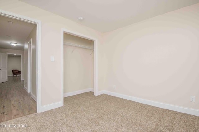 unfurnished bedroom featuring carpet flooring and a closet