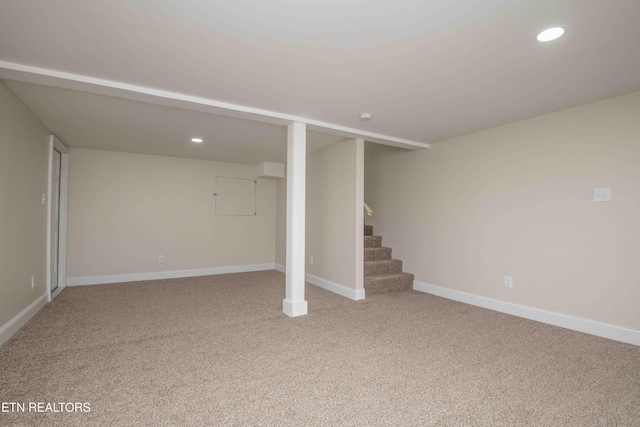 basement featuring light colored carpet