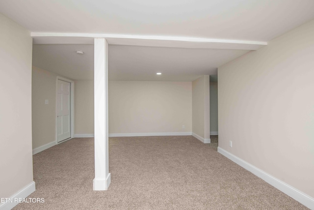 basement featuring light colored carpet