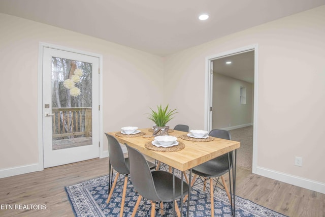 dining space with hardwood / wood-style flooring