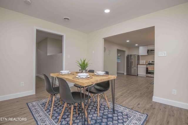 dining room with wood-type flooring