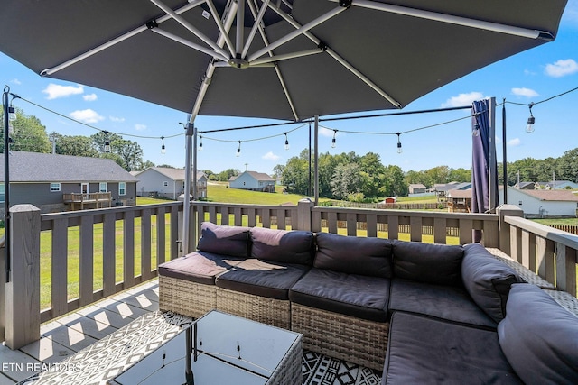 deck featuring a lawn and outdoor lounge area