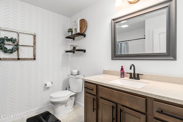 bathroom featuring tile patterned flooring, vanity, toilet, and walk in shower