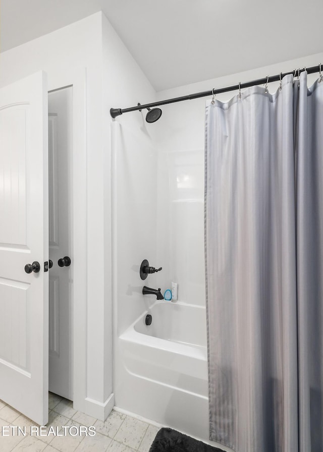 bathroom featuring tile patterned flooring and shower / bathtub combination with curtain