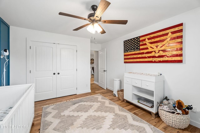 bedroom featuring ceiling fan, light hardwood / wood-style floors, and a closet